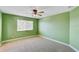 Bedroom with green walls, ceiling fan, and window with blinds at 1346 Western Pine Cir, Sarasota, FL 34240