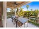 Covered balcony with outdoor dining set and pool view at 150 Grant Dr, Sarasota, FL 34236