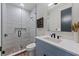 Bathroom with a walk-in shower and blue vanity at 150 Grant Dr, Sarasota, FL 34236