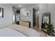 Bedroom with ensuite bathroom and large TV at 150 Grant Dr, Sarasota, FL 34236