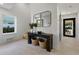 Bright entryway with contemporary console table and mirrors, leading to other rooms at 150 Grant Dr, Sarasota, FL 34236