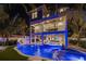 Luxury home with pool, spa, and slide at night at 150 Grant Dr, Sarasota, FL 34236