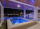Relaxing hot tub with blue lighting and stone surround at 150 Grant Dr, Sarasota, FL 34236