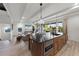 Open concept kitchen with island, built-in oven, and view into living area at 150 Grant Dr, Sarasota, FL 34236