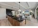 Open kitchen with large island, breakfast bar seating, and view into living room at 150 Grant Dr, Sarasota, FL 34236