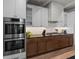 Modern kitchen with double ovens, gas cooktop and stylish cabinetry at 150 Grant Dr, Sarasota, FL 34236