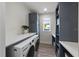 Bright laundry room with washer, dryer, and shelving at 150 Grant Dr, Sarasota, FL 34236