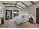 Spacious main bedroom with a large bed, stylish decor, and a balcony view at 150 Grant Dr, Sarasota, FL 34236