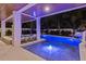 Luxury pool at night with hot tub and slide at 150 Grant Dr, Sarasota, FL 34236
