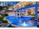 Stunning pool and spa area with a waterslide at dusk at 150 Grant Dr, Sarasota, FL 34236
