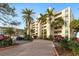 Exterior view of a multi-story building with palm trees and parking at 1510 1St W Ave # 504, Bradenton, FL 34205