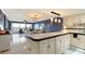 Kitchen boasts white cabinets, black appliances, and a breakfast bar at 1510 1St W Ave # 504, Bradenton, FL 34205