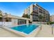 Community pool with surrounding patio furniture at 1510 1St W Ave # 504, Bradenton, FL 34205