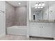 Modern bathroom with a white soaking tub and granite countertop at 17825 Gawthrop Dr # 104, Bradenton, FL 34211