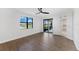 Bright bedroom with wood-look floors and sliding doors to patio at 17825 Gawthrop Dr # 104, Bradenton, FL 34211