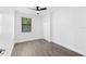 Spacious bedroom with wood-look floors and ceiling fan at 17825 Gawthrop Dr # 104, Bradenton, FL 34211