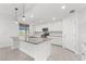 Modern kitchen with white cabinets and granite island at 17825 Gawthrop Dr # 104, Bradenton, FL 34211