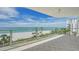 Enjoy breathtaking beach views from the spacious balcony, complete with tile flooring and modern glass railings at 1800 Benjamin Franklin Dr # A405, Sarasota, FL 34236