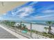 Another view of the balcony overlooking a white sand beach with palm trees, offering a serene and picturesque setting at 1800 Benjamin Franklin Dr # A405, Sarasota, FL 34236