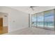 Bright bedroom with carpet and large windows showcasing ocean views and providing access to a private balcony at 1800 Benjamin Franklin Dr # A405, Sarasota, FL 34236