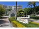 Elegance building exterior showcasing lush landscaping, a guard house and a view of the condos at 1800 Benjamin Franklin Dr # A405, Sarasota, FL 34236
