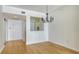 Dining room with hardwood floors and chandelier at 1800 Benjamin Franklin Dr # A405, Sarasota, FL 34236