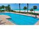Relaxing in the pool with a view of the beach and ocean beyond at 1800 Benjamin Franklin Dr # A405, Sarasota, FL 34236