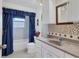 Clean bathroom with updated vanity and tiled shower at 2271 Sandlewood Dr, Venice, FL 34293