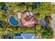 Aerial view showcasing a house with a kidney-shaped pool and lush landscaping at 235 Grant Dr, Sarasota, FL 34236
