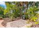 Brick paved patio with a built-in grill and tropical landscaping at 235 Grant Dr, Sarasota, FL 34236