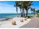 Scenic beachfront path with palm trees and ocean views at 235 Grant Dr, Sarasota, FL 34236
