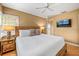 Spacious main bedroom with a king-size bed, TV, and wood nightstands at 235 Grant Dr, Sarasota, FL 34236