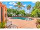 Relaxing kidney-shaped pool with patio chairs and lush landscaping at 235 Grant Dr, Sarasota, FL 34236