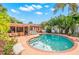 Charming home with a kidney-shaped pool and patio furniture at 235 Grant Dr, Sarasota, FL 34236