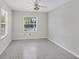 Simple bedroom with terrazzo floor and window at 2605 Desoto Rd, Sarasota, FL 34234