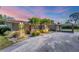 Single-story home with red tile roof, palm trees, and a covered carport at 2605 Desoto Rd, Sarasota, FL 34234