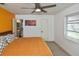 Bright bedroom with king-size bed, ensuite bathroom access and ceiling fan at 3111 Taunton W Dr, Bradenton, FL 34205