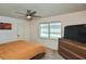 Relaxing bedroom with a large window, dresser, and flat screen TV at 3111 Taunton W Dr, Bradenton, FL 34205