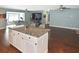 Open concept kitchen and living area with an island and hardwood floors at 3111 Taunton W Dr, Bradenton, FL 34205