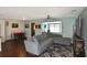 Open concept living room and kitchen with dark hardwood floors and sectional sofa at 3111 Taunton W Dr, Bradenton, FL 34205