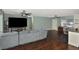 Living room with sectional sofa, large TV, and hardwood floors at 3111 Taunton W Dr, Bradenton, FL 34205