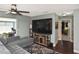 Living room with sectional sofa, large TV, and hardwood floors at 3111 Taunton W Dr, Bradenton, FL 34205