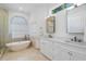 Elegant bathroom with a freestanding bathtub, dual sinks, and a walk-in shower at 3260 Bayou Rd, Longboat Key, FL 34228