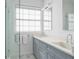 Modern bathroom with dual vanities, a large mirror, and a walk-in shower at 3260 Bayou Rd, Longboat Key, FL 34228