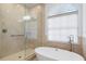 Spa-like bathroom featuring a soaking tub, a large shower, and stylish fixtures at 3260 Bayou Rd, Longboat Key, FL 34228