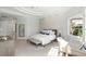 Bright bedroom with a comfortable bed, a work desk, and plenty of natural light at 3260 Bayou Rd, Longboat Key, FL 34228