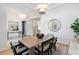 Modern dining room with large windows and a wood table at 3260 Bayou Rd, Longboat Key, FL 34228