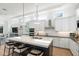 Modern kitchen with island, stainless steel appliances, and white cabinetry at 3260 Bayou Rd, Longboat Key, FL 34228