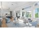 Open living space with kitchen, dining and access to patio at 3260 Bayou Rd, Longboat Key, FL 34228