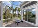 Relaxing screened-in patio area with seating overlooking the pool at 3260 Bayou Rd, Longboat Key, FL 34228